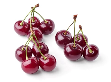 Three groups of juicy cherries view from top on white background