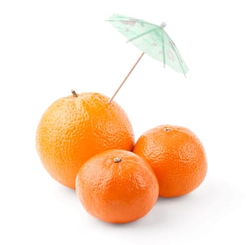 Tangerines and orange under umbrella isolated on white background