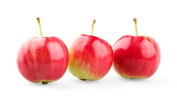 Three mini apples in row isolated on white background