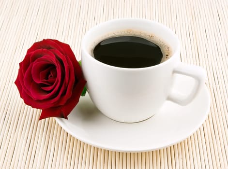 Coffee cup and rose isolated on white background