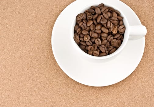 Coffee cup filled with coffee beans