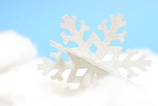 A white snowflake ornament on a white and blue background.