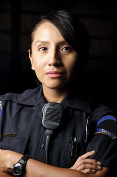 a female police officer posing for her portrait at night.