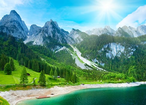 Beautiful summer Alpine mountain  lake view and sunshine in sky