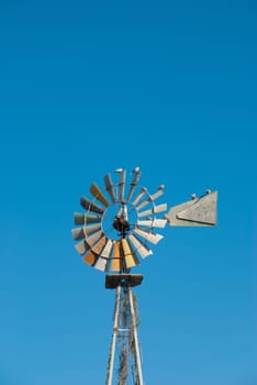 Traditional windmill pump extracting water from a well