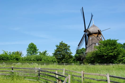 Traditional wooden wind mill in a museum in Denmark
