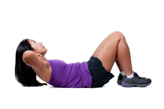 A beautiful young Asian woman exercising by doing crunches
