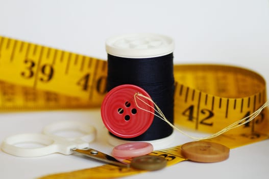 Some sewing tools such as threads, needles, buttons, and scissors