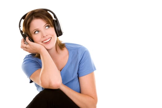 pretty casual brunette is listening to music on white background