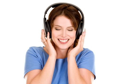 pretty casual brunette is listening to music on white background
