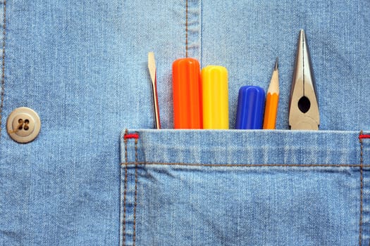 Closeup of denim pocket with color work tools