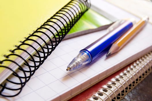 Notebooks with pen and pencil