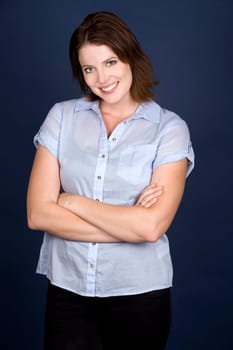 pretty casual brunette wearing blue top on dark background