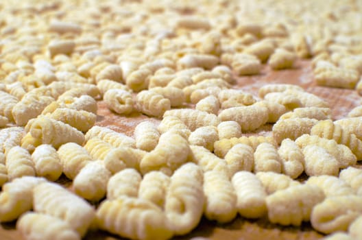 Uncooked gnocchi - background with traditional italian pasta