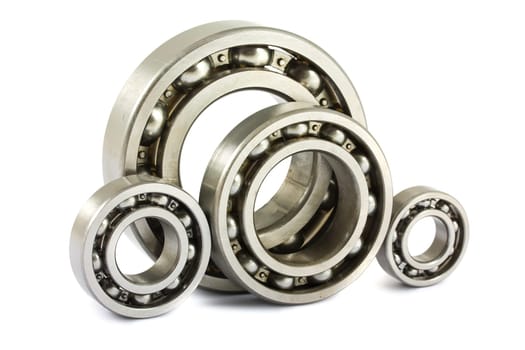 Four steel ball bearings isolated on a white background