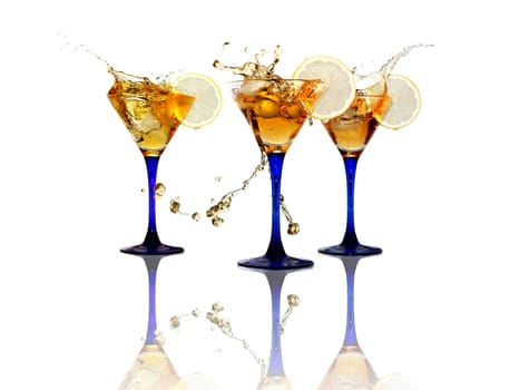 Three wineglasses with splashing beverage and lemon on white background. Isolated with clipping path