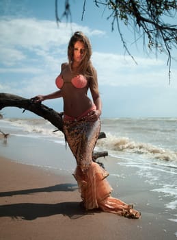 beautiful woman in exotic dress standing on the beach. Sea ​​of ​​Azov