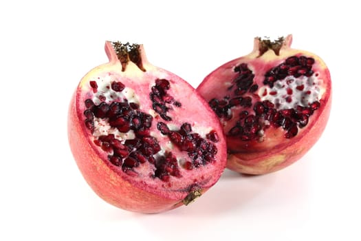fresh sliced pomegranate on a white background