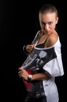 A beautiful young woman on a black background in studio