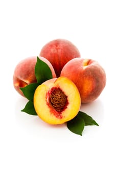 photo of delicious tasty peaches on white background with leaves