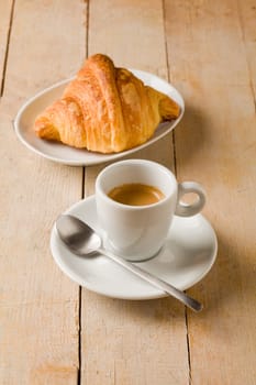 photo of fresh coffee and croissants on brown wooden table