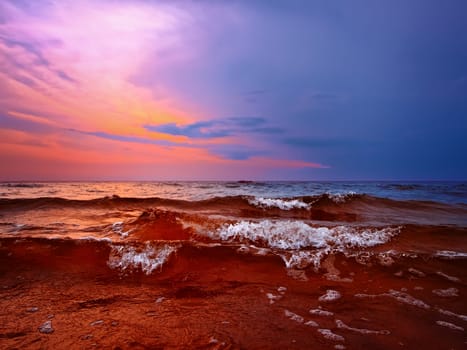 Bright sunset above the wavy sea