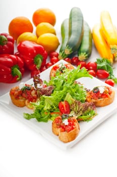 original Italian fresh bruschetta,typical finger food, with fresh salad and vegetables on background,MORE DELICIOUS FOOD ON PORTFOLIO