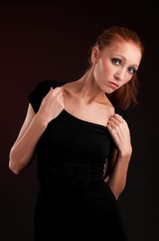 portrait of a young redhead woman in black dress
