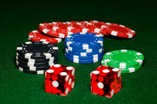 Gambling chips and craps dice on gaming table