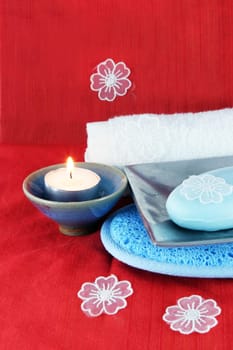 Burning candle with soap in a dish - spa products