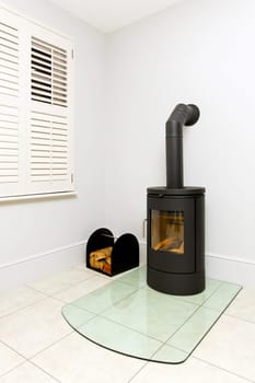 Freestanding black cast iron wood burning stove.