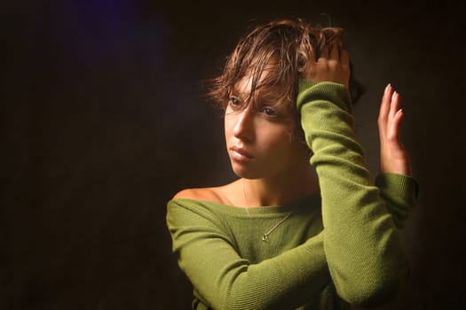 Portrait of the beautiful girl with crossed with hands