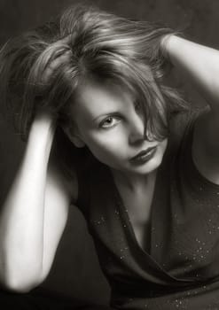 The image of the girl her hands keep for a head. b/w+sepia