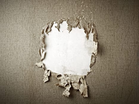 close up of a hole in a wallpaper