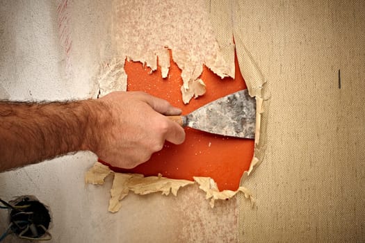 close up of a hand holding a spatula for renovation