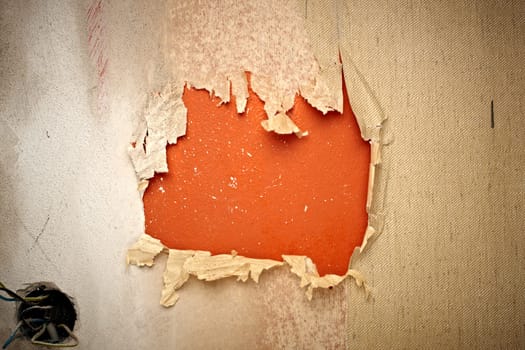 close up of a orange hole in a wallpaper