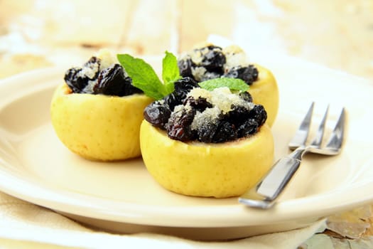 dessert of baked apple with raisins and sugar