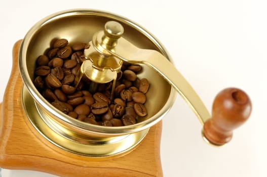 Stock photo of a Coffee grinder with coffee beans close-up Isolated over white background