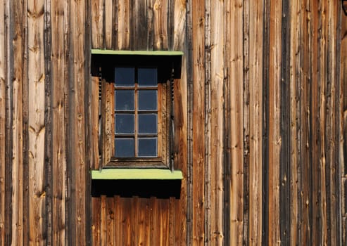 Old wooden building close up of a wall with a window