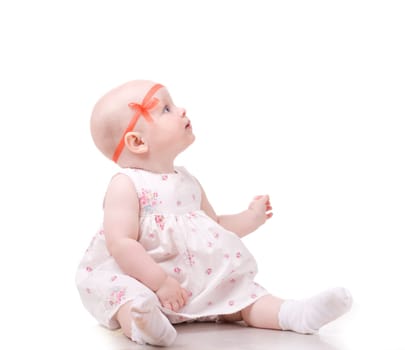 Sweet baby girl looking at something. Isolated over white background.