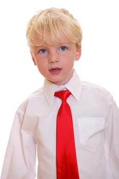 Portrait of a young blond boy wearing a red tie on white background