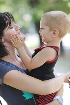 happy children and mom have fun at beautiful park on summer season