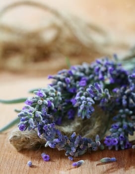 Lavender bouquet with seeds on a wooden table.