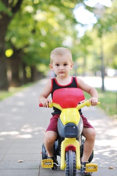 happy children in park ride cycle at park on summer season