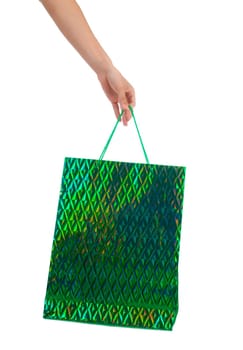 Female hand holding colorful shopping bags on white