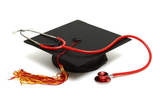 An isolated mortarboard and stethoscope to conceptualize the medical graduate.