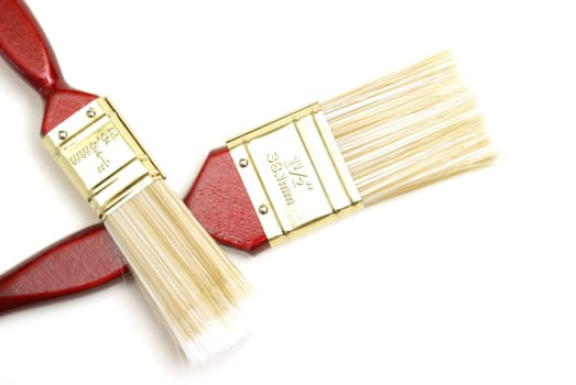 Two wooden paintbrushes over a white background.