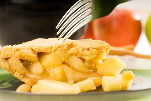 fresh homemade apple pie over green glass dish macro colseup eating  with fork