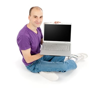 Happy young man holding laptop computer with blank screen