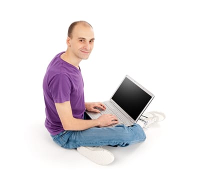 Young man sitting and using a laptop